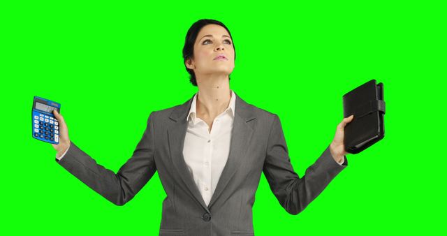 This visual portrays a confident businesswoman dressed in a suit holding a calculator in one hand and a planner in the other, both against a vibrant green background. The green backdrop allows for easy editing and overlay, making it versatile for various corporate and professional projects. Ideal for use in presentations, finance-related articles, business planning guides, motivational quotes, and marketing materials relating to productivity and effectiveness in the workplace.