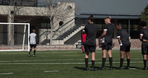 Soccer Players in Training Preparing for Curling Free Kick Challenge