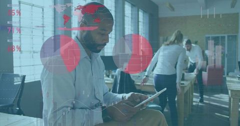 Man Using Tablet in Open Office with Data Analytics Overlay and Team Collaboration