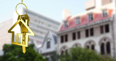 Golden Key with House Icon Simulating Urban Real Estate Concept