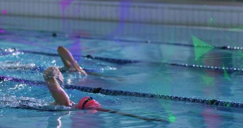 Swimmer in Pink Cap Practicing Freestyle Stroke in Indoor Pool