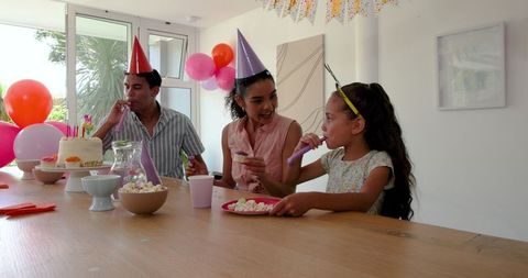 Family enjoying birthday celebration with party decorations