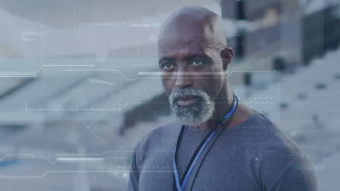 Senior Trainer Analyzing Sports Data with Technology Interface