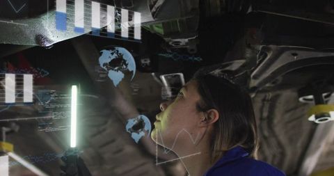 Female Technician Inspecting Vehicle Undercarriage with AR Diagnostics and LED Wand