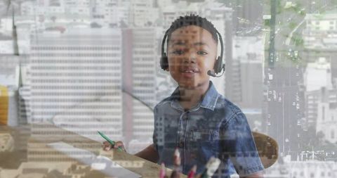 Young student wearing headset studying at home desk with city skyline double exposure