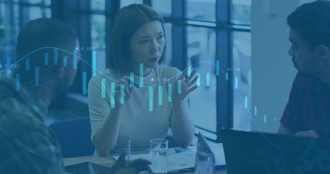 Colleagues Analyzing Financial Trends in Modern Office Setting