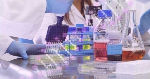 Pipetting Multichannel into 96-Well Plate with Colorful Reagents and Lab Glassware