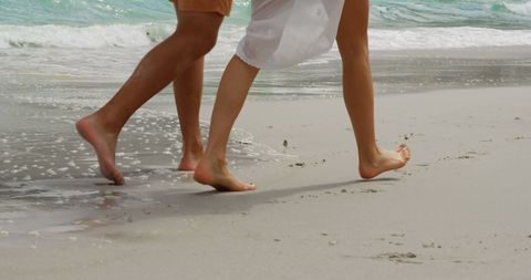 Couple Walking Barefoot Along Seashore Beach Relaxation - Download Free Stock Images Pikwizard.com