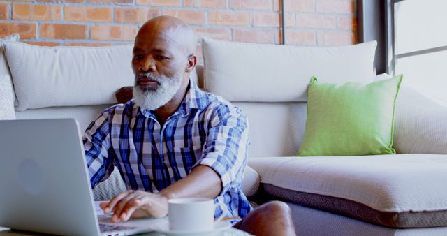 Senior Man Using Laptop in Cozy Living Room - Download Free Stock Images Pikwizard.com