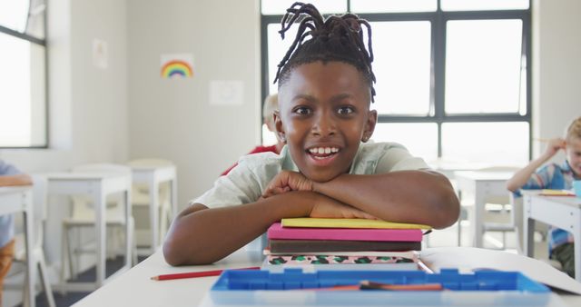 Smiling Boy Sitting in Classroom with Books - Download Free Stock Images Pikwizard.com