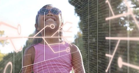 Smiling child wearing sunglasses gazing through ar interface in sunlit backyard