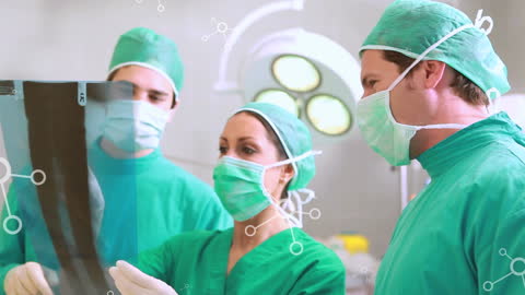 Medical Professionals Analyzing X-ray with Digital Interface