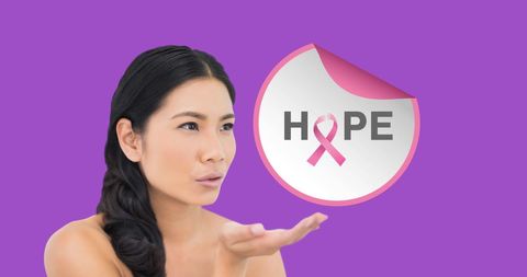 Asian Woman Supporting Breast Cancer Awareness with Hope Symbol