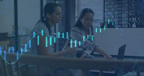 Businesswomen Analyzing Financial Charts on Laptop