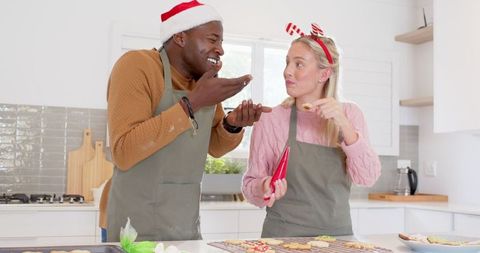 Joyful Couple Decorating Christmas Sugar Cookies Together