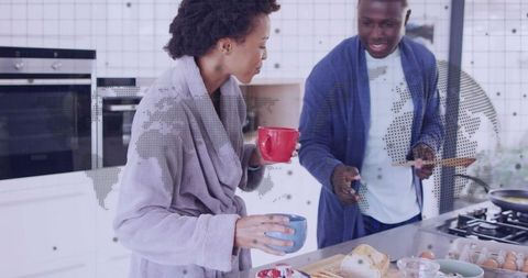 Couple enjoying cozy breakfast in robes at modern kitchen island with world map overlay