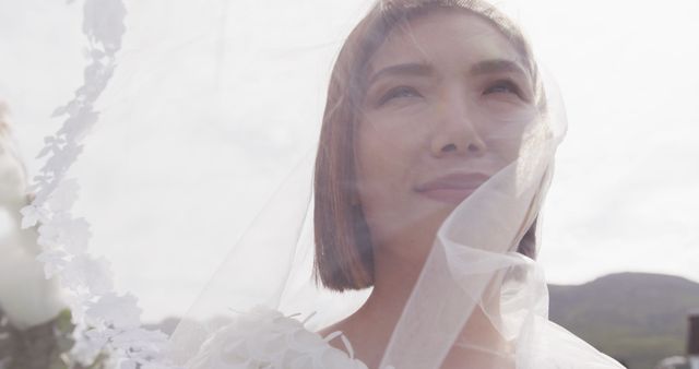 Image of happy asian bride in veil smiling at outdoor wedding. Marriage, love, happiness and inclusivity concept.