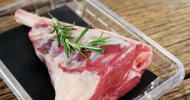 Raw Lamb Meat with Fresh Rosemary on Wooden Table - Download Free Stock Images Pikwizard.com