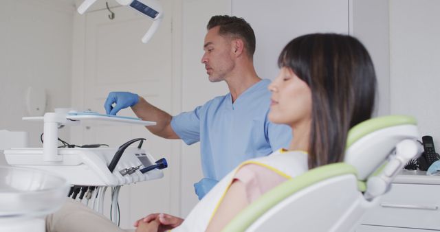 Dentist Preparing Equipment While Female Patient Waits - Download Free Stock Images Pikwizard.com