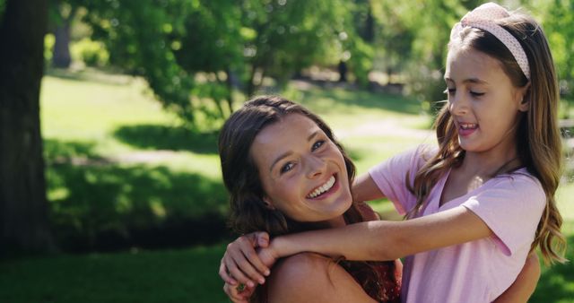 Mother and Daughter Hugging in Sunlit Park - Download Free Stock Images Pikwizard.com