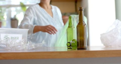 Woman Sorting Recyclable Glass Bottles on Kitchen Counter - Download Free Stock Images Pikwizard.com