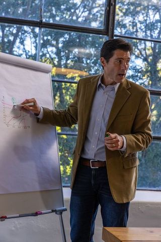 Business Professional Presenting Chart in Modern Office Setting