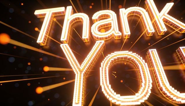 Glowing led thank you marquee typography sending light beams, sparks and cinematic bokeh