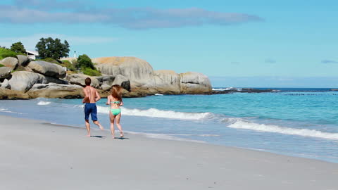 Romantic Couple Jogging Together on Beach