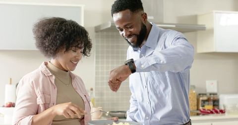 African American Couple Cooking Breakfast Together in Bright Modern Kitchen