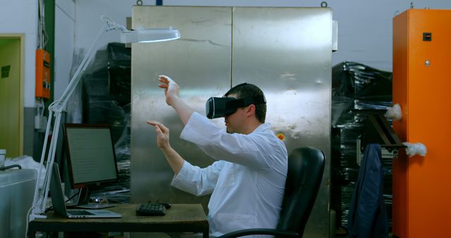 Engineer developing technology and testing virtual reality gadgets in an industrial setting. Useful for content related to modern industrial innovations, VR technology, and research and development in engineering. Ideal for detail demonstrations and visualizations in technology-centric publications and presentations.