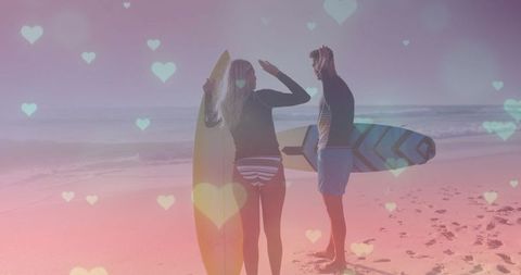 Couple with surfboards enjoying romantic beachscape