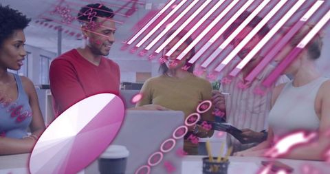 Diverse team collaborating around laptop with pink augmented reality data overlays