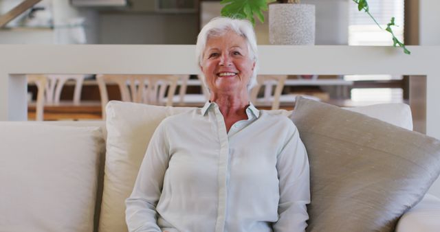 Smiling Elderly Woman Relaxing on Cozy Sofa at Home - Download Free Stock Images Pikwizard.com