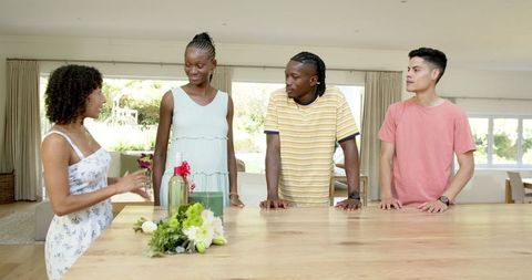 Young Friends Gather in Bright Kitchen for Social Celebration