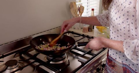 Rustic Homemaker Stirring Vegetables in Modern Kitchen Wok - Download Free Stock Images Pikwizard.com
