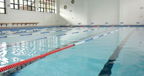 Empty indoor swimming pool with lane dividers for training and competition