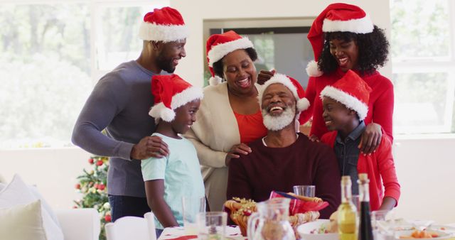 Smiling Family Celebrating Christmas Together with Santa Hats - Download Free Stock Images Pikwizard.com