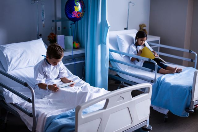 Patients with digital tablet and book sitting on bed at hospital