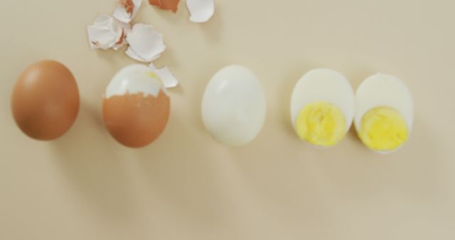 Showcasing progression from whole boiled egg to peeled egg and sliced halves. Ideal for recipes, cooking blogs, nutrition articles, and educational materials on food preparation. Highlights simplicity and cleanliness, making it suitable for minimalist designs and healthy eating promotions.
