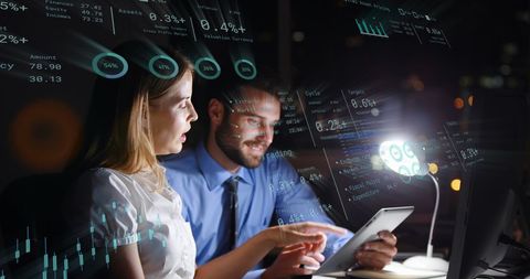 Business professionals analyzing financial data at night