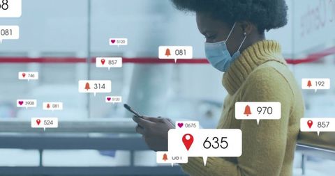 Masked woman receiving notifications on smartphone in urban setting