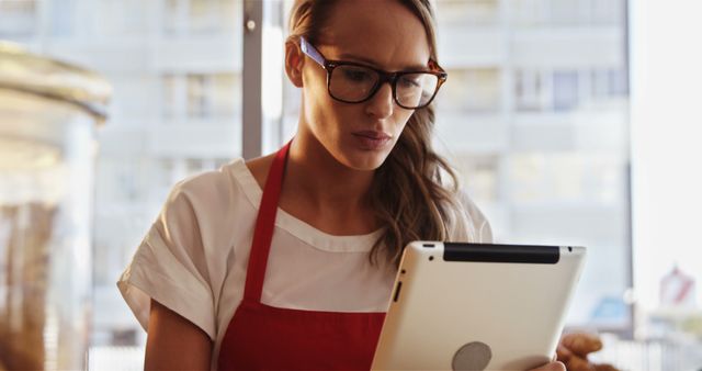 Barista with Glasses Using Tablet in Coffee Shop - Download Free Stock Images Pikwizard.com