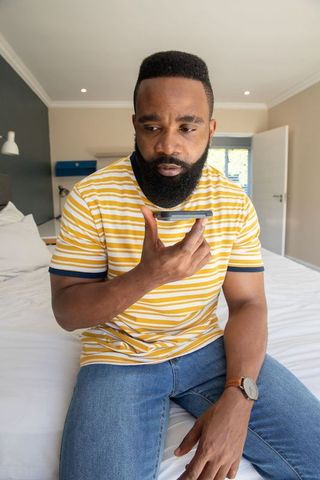 Casual Relaxation African American Man Sitting in Modern Bedroom
