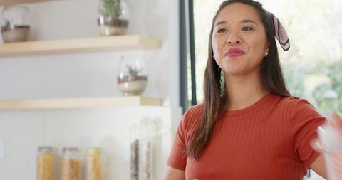 Smiling Asian Woman Chatting in Stylish Kitchen Environment