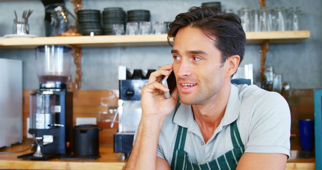 Smiling Barista Taking Phone Call at Cafe Counter - Download Free Stock Images Pikwizard.com