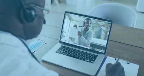 Telemedicine Consultation Doctor Taking Notes During Virtual Call