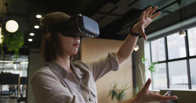 Woman Engaging with Virtual Reality Technology in Modern Office - Download Free Stock Images Pikwizard.com