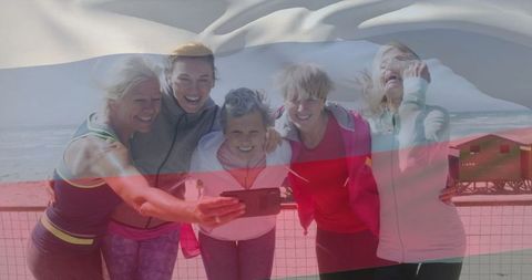 Group of Active Women Taking Selfie on Scenic Boardwalk