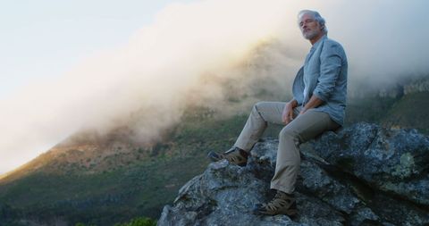 Elderly Man Enjoying Scenic Mountain View at Dusk - Download Free Stock Images Pikwizard.com