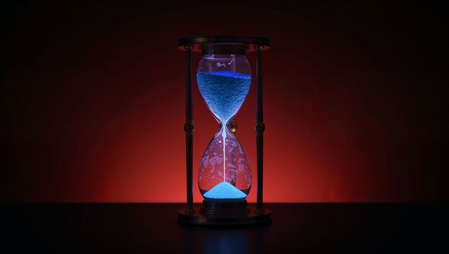 Innovative hourglass with glowing blue sand on bold gradient